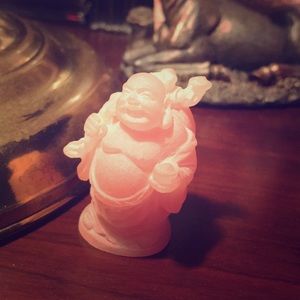 Small plastic figurine of a pink Buddha.Like new